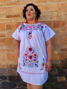 "Hand Embroidered Mexican Tunic Style dresses. EACH DRESS HAS UNIQUE COLORFUL EMBROIDERY. EACH ONE HAS UNIQUE PATTERN EMBROIDERY. Dresses wearing the women models aren't available. This are just for display to see how dresses look wearing them. FABRIC: poplin CARE : hand wash only. SIZES AND MEASUREMENTS: SIZE SMALL : (6US) Length: 36\" Armpit to armpit: 20\" SIZE MEDIUM: (8-10US) Length: 37\" Armpit to armpit: 21\" SIZE LARGE : (12-14 US) Length: 38\" Armpit to armpit: 23\" SIZE EXTRA LARGE : ( White Geometric Embroidered Short Sleeve Dress, White Short Sleeve Embroidered Dress With Geometric Pattern, White Short Sleeve Dress With Geometric Embroidery, White Embroidered Dress With Short Sleeves, Mexican Dresses For Women, Women Models, Embroidery Dresses, Embroidered Dresses, Mexican Outfit