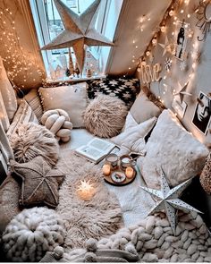 a bed with lots of pillows and lights on it