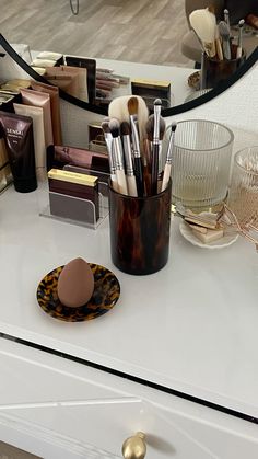 makeup brushes and other items on a dresser