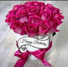 a bouquet of pink roses in a white box with a happy birthday ribbon on it