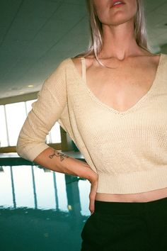 Cozy summer knit bra top with large hook closure. Cream fabric is 100% linen. Ella is 6' tall, 35" bust, 26" waist, 36" hip, and is wearing a size S. Low-cut Tops With Built-in Bra For Loungewear, Seamless V-neck Crop Top For Day Out, Chic Cropped Pointelle Knit Crop Top, Knit V-neck Crop Top For Day Out, Chic Pointelle Knit Crop Top, V-neck Crop Top With Built-in Bra For Beach, Seamless V-neck Crop Top For Vacation, Summer Pointelle Knit Top For Loungewear, Chic Low-cut Summer Top