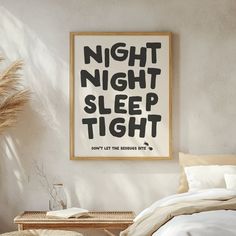 a poster hanging on the wall above a bed