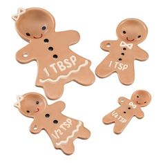 four ginger cookies with the words itbsp and two little ones on them, all decorated in different shapes