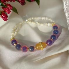 Introducing our Chinese vintage style beaded bracelet that one side is made in gradient purple color agate beads, and the other side is made in small white color agate beads. the charm represents luck and peace. It is a great calming accessory to keep for yourself or to gift for your friends! Purple Agate Bracelets With Natural Stones, Spiritual Agate Beaded Bracelets With Colorful Beads, Purple Agate Bracelets, Purple Agate Bracelet With Natural Stones, Purple Agate Bracelets With Gemstone Beads, Purple Agate Bracelet With Gemstone Beads, Purple Agate Gemstone Beads Bracelets, Purple Agate Gemstone Beads Bracelet, Bohemian Moonstone Beaded Bracelets With 8mm Beads