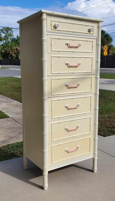 an old dresser is painted white with pink handles