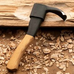 a hammer is stuck in wood shavings