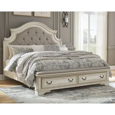 a white bed with two drawers underneath it