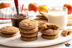 cookies and milk on a plate with apples in the background