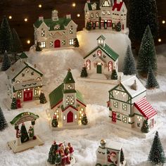 a christmas village with lights and trees