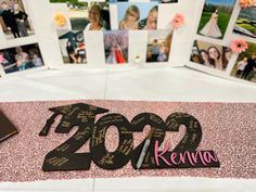 a table topped with pictures and writing next to a pink table cloth covered in photos