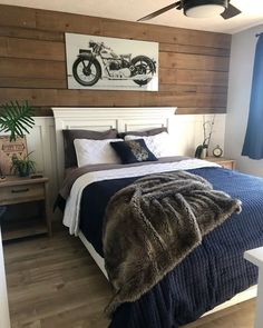 a bedroom with wood paneling and a large bed