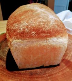 a loaf of bread sitting on top of a wooden table