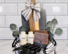 a basket filled with kitchen utensils on top of a counter next to a tiled wall