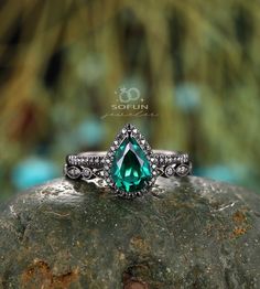 a green ring sitting on top of a rock