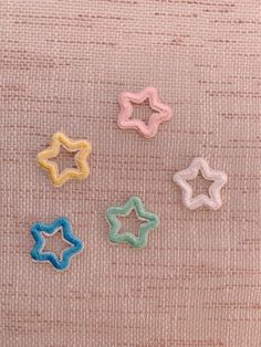 four little stars on a pink fabric background