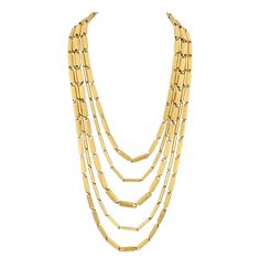 This chic Henry Dunay necklace makes a bold statement around the neck, with its five-strand multi-link design exuding classic elegance. Crafted meticulously from 18K yellow gold, the necklace cascades with fluid movement that embodies Dunay's signature style—sophisticated, timeless and detailed. Henry Dunay, an acclaimed American jeweler known for his innovative designs and exquisite craftsmanship, has long been celebrated in the world of fine jewelry. His pieces are often characterized by bold, Luxury Multi-strand Chain Necklace For Formal Occasions, Luxury Multi-strand Chain Necklace For Formal Events, Luxury Multi-strand Necklace For Formal Occasions, Gold Multi-strand Chain Necklace In Luxury Style, Yellow Gold Multi-strand Necklaces For Formal Occasions, Luxury Gold Multi-strand Chain Necklace, Luxury Multi-strand Gold Chain Necklace, Luxury Gold Multi-strand Necklace, Luxury Multi-strand Gold Necklace