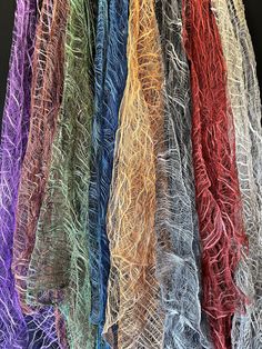 there are many different colored yarns hanging together