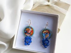 Sicilian style earrings made of: - Lava rock tiles decorated on a side with Sicilian Ceramic; - Faceted stones (6 mm), blue color; - Brass open hooks. Tile Diameter: 25 mm Lenght : 5,5 cm / 2,17 inches * SHIPPING * Your order will be shipped within 1-3 business days from your purchase. You can choose between 2 shipping methods: STANDARD SHIPPING (without tracking) or REGISTERED MAIL (with tracking). Each chapeau atelier jewel is shipped in a gift box. Thank you for your visit. Rock Tile, Sicilian Style, Tile Earrings, Lava Rock, Style Tile, Baroque Fashion, Style Earrings, Earrings Photo, Deodorant