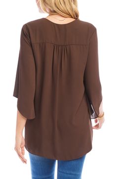 An elegant top of silky, lightweight crepe delivers elegant movement with its angled flare sleeves and fluttery asymmetrical hemline that dips low in back. 25 1/2" length (size Medium) V-neck Three-quarter sleeves Back yoke with gathering Crossover high/low hem 100% polyester Dry clean or hand wash, line dry Made in the USA of imported fabric Women's Clothing Elegant Brown V-neck Blouse, Flowy Asymmetrical Hem Blouse For Spring, Flowy Blouse With Asymmetrical Hem For Spring, Flowy Spring Blouse With Asymmetrical Hem, Elegant Silk V-neck Tunic, Chic Flowy Blouse With Asymmetrical Hem, Elegant Flowy Blouse For Fall, Chic Flowy Blouse For Workwear, Flowy Chiffon Blouse For Work