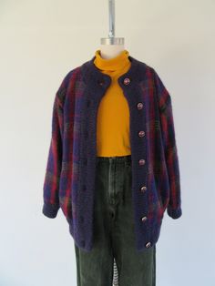 80s banded mohair button front cardigan cocoon jacket. Plaid. Eggplant with fuchsia, black, and olive. Side pockets. Fully lined in purple nylon fabric. Body material unknown, but probably a mohair wool blend. Gold tone resin with purple center buttons. Made for LHIN YING Ladies Fashion Wear.  Label size not present fits like M, maybe L 20" shoulder to shoulder  23" pit to pit 29" top to bottom  21" sleeves Good vintage condition with minimal signs of use and age. Puffy Sweater, Knit Plaid, Cocoon Jackets, Mohair Knit, Cardigan Sweater Coat, Button Front Cardigan, Mohair Wool, Mohair Sweater, Sweater Coat