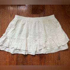 White Brandy Melville Mini Skirt -New With Tag -Flowy Tiered Mini Skirt With A Stretchy Waist Line And Ruffle Seams. -Fabrics: 100% Viscose -Measurements: 13" (33 Cm) Length, 13" (33 Cm) Waist (Stretches) Mini Flowy Skirt, Casual Mini Tennis Skirt With Ruffles, Flowy Lined Mini Hem Skort, White Mini Skort With Ruffle Hem, White Ruffle Hem Mini Skort, Casual Ruffled Mini Skort, Casual Cotton Mini Skirt With Ruffle Hem, Cotton Lined Mini Skirt For Brunch, Cotton Mini Skirt With Ruffle Hem