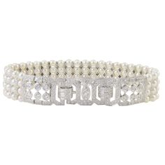 This exquisite estate bracelet features 3.50 CTW of diamonds and four strands of pearls. This 7 inch 18 karat white gold bracelet has round diamonds at approximately 3.50 carat total weight VS-SI clarity H-I color and four strands of natural Japanese pearls. This pearl and diamond bracelet is appraised at $11,300. Dimensions: 7″L x .62″H x .20″D at clasp SKU #ADTI 38 Classic Diamond Pearl Bracelet For Formal Occasions, Elegant Pearl Bracelet With Diamond Accents, Classic White Gold Diamond Pearl Bracelet, Elegant White Gold Pearl Bracelet With Diamonds, Formal Diamond Pearl Bracelet With Jubilee Style, Wedding Pearl Bracelet With Diamonds, Wedding Fine Jewelry Diamond Pearl Bracelet, Fine Jewelry Diamond Pearl Bracelet For Wedding, White Pearl Diamond Bracelet For Anniversary