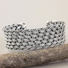 Woven by hand of sterling silver strands this beautiful design recreates a traditional basketweave. Achara presents a cuff bracelet of rich textures crafted by talented artisans of Thailand's Karen hill tribe. Tribe Jewelry, Silver Wrap Ring, Pola Gelang, Diy Wire Jewelry, Wire Work Jewelry, Handmade Wire Jewelry, Sterling Silver Cuff Bracelet, Unique Jewelry Designs, Sterling Silver Cuff