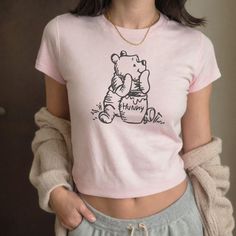 Winnie The Pooh Baby Tee Designed and Printed in the USA Our shirts are bestseller Gildan 5000B which is a high-quality heavy cotton tee that aims to produce shirts that are sustainable and ethical as well as striving to be eco-friendly.  It has a ribbed knit collar without seam which makes the collar elastic and helps retain its shape. The shoulder has a twill tape for improved durability, which stabilizes the back and prevents it from stretching. The collar is curl resistant due to ribbed knit Coquette Shirt, Pooh Baby, Vintage Winnie The Pooh, Baby Tees Y2k, Curious George, Baby Tees, Baby T Shirts, Bookish Gifts, Baby T Shirt