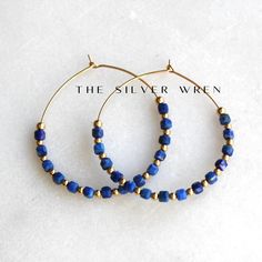 Lapis Gold Hoop Earrings D E T A I L S These gorgeous hoop earrings are created with Genuine Natural Lapis 3mm lapis cube beads and 14kt gold filled accents   Beaded by hand  14kt gold filled 35mm hoops  ∙ EXTRA LOVE ∙ Crafted and curated just for you in the desert of our Arizona studio. All of our jewelry comes gift packaged!  We are happy to leave a note if this is a special gift, just let us know in the message box at checkout.  PRODUCTION ∙ TIMES All items are made to order. Please check the Jewelry Gold Earrings, Lapis Jewelry, Lapis Earrings, Cube Beads, Gift Best Friend, Gold Jewelry Earrings, Friend Gifts, Message Box, Gold Filled Jewelry