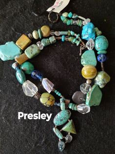 "Presley " I make my jewelry with the picky fashion diva in mind.  She never wears ordinary and her sassy attitude rules her jewelry box. Unique custom necklace. The one of a kind pendant includes turquoise, topaz and moonstone. It is complimented by a array of turquoise , green coral,moonstone, tumbled stone  and  Bali silver.  Let my jewelry call your name. Obsidian custom gemstone pendant  Toggle closure.  The necklace measures 21". Fast Free Shipping Item #505 Unique Hand-strung Turquoise Beaded Necklace, Unique Hand-strung Turquoise Jewelry, Turquoise Beaded Fusion Jewelry, Artisan Turquoise Beaded Necklaces With Stones, Unique Multi-strand Turquoise Jewelry, Unique Turquoise Multi-strand Jewelry, Turquoise Artisan Beads For Jewelry Making, Artisan Turquoise Beads For Jewelry Making, Handmade Artisan Turquoise Beads