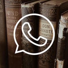 a book shelf with old books and a phone in the middle that says don quixote