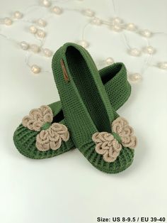 pair of green slippers with flowers on them