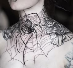 a woman with spider web tattoo on her chest