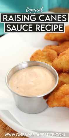 a white plate topped with tater tots and dipping sauce