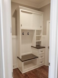 an empty room with white cabinets and drawers