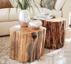 two wooden tables sitting on top of a carpeted floor next to a white couch