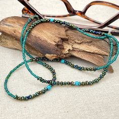 Rich and bohemian eye glasses necklace chain in green and turquoise tones with small Turquoise beads.  A beaded bohemian, western style handmade eyeglass chain that will definitely create a unique look. This eyeglass lanyard is made on strong quality beading wire with silver plated wire guardians that protect the quality eyeglass holder grips. The necklace is ended with spring clasps that hold the eyeglass grips and they can be easily removed to transform the necklace into a mask holder. FREE Sh Glasses Cord, Eyeglass Jewelry, Grandma Birthday Gift, Glasses Necklace, Green Gemstone Necklace, Eyeglasses Chain, Eyeglass Necklace, Mask Holder, Birthday Gifts For Grandma