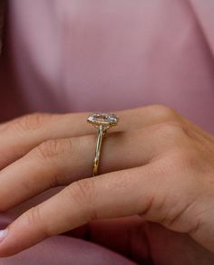 a woman's hand with a diamond ring on it