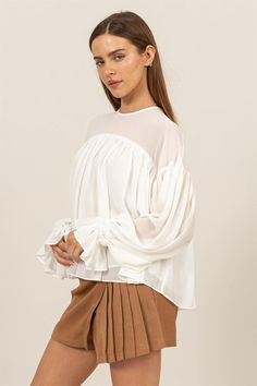 ELEVATE YOUR STYLE WITH THIS FLOWY LONG SLEEVE BLOUSE. FEATURING DRAMATIC GATHERED CUFFS AND A RELAXED, AIRY FIT, THIS BLOUSE OFFERS BOTH COMFORT AND ELEGANCE. PERFECT FOR A CASUAL DAY OUT OR A SPECIAL OCCASION, ITS UNIQUE DESIGN ADDS A TOUCH OF SOPHISTICATION TO ANY OUTFIT. Chic Shack, Sweet Grace, Romper With Skirt, Scarf Hairstyles, The Chic, Elevate Your Style, Dress Skirt, Your Style, Short Sleeves Tops