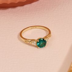 Crafted in 14k Solid Gold, our Braided Arctic Green Engagement Ring is a vintage-inspired masterpiece. The captivating Green-hued gemstone, intricately braided band, and delicate accents create a unique and elegant piece. Whether for an engagement or an anniversary, this ring symbolizes enduring love and timeless beauty. Make her heart skip a beat with this exquisite ring that's as extraordinary as she is. Ring Details * Gold Kt: 10k 14k 18k Solid Gold * Band Options; Yellow Gold, White Gold, Ro Classic Emerald Ring With Round Stone, Fine Jewelry Emerald Ring With Center Stone For Promise, Classic Emerald Ring With Round Stone For Anniversary, Fine Jewelry Emerald Promise Ring With Center Stone, Timeless Emerald Ring With Accent Stones As Gift, Classic Diamond Ring With Accent Stones For May Birthstone, Yellow Gold Emerald Birthstone Ring For Promise, Promise Emerald Birthstone Ring In Yellow Gold, Art Deco Round Emerald Ring With Center Stone