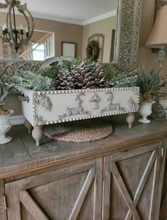 a dresser with pine cones and other decorations on it