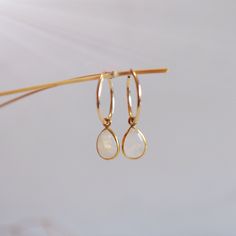 Hoop earrings are a classic accessory that never goes out of style. These moonstone earrings are classy to go with every outfit. They are sure to bring you compliments where ever you go. Stunning Rainbow Moonstone charms upon gold filled hoops. 31mm x 16mm 14K Gold Filled 16mm hoop with 14x8mm charm White 14k Gold Filled Hoop Earrings, Dainty Teardrop Huggie Earrings, White Moonstone Earrings For Daily Wear, Minimalist Teardrop Huggie Earrings As Gift, Delicate Teardrop Hoop Earrings For Gift, Delicate Teardrop Hoop Earrings As Gift, Delicate 14k Gold Filled Huggie Earrings, Minimalist Hypoallergenic Hoop Earrings For Her, Minimalist Moonstone Jewelry For Everyday