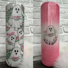 two pink tumbles with ghost and watermelon designs on them, sitting next to each other