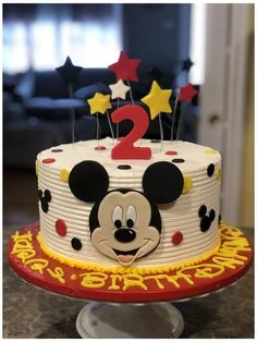 a mickey mouse birthday cake sitting on top of a table