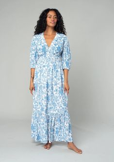 A flowy bohemian maxi dress in a white and blue floral print, with a smocked waist detail. Relaxed fit Half-length puff sleeves Elastic cuffs Maxi length Tiered skirt Elastic-trimmed v-neckline Smocked waist detail Bohemian maxi dress Flowy and feminine, this ultra-flattering maxi dress is designed in a beautiful vintage-inspired floral print. Casual Billowy Floral Print Maxi Dress, Casual Billowy Maxi Dress With Floral Print, Spring Maxi Dress With Elastic Puff Sleeves, Long Sleeve Maxi Dress With Smocked Cuffs For Vacation, Flowy Floral Print Maxi Dress With Puff Sleeves, Spring Daywear Maxi Dress With Elastic Sleeves, Spring Blue Dress With Elastic Waistband, Bohemian Dress With Smocked Cuffs For Day Out, Casual V-neck Maxi Dress With Elastic Sleeves