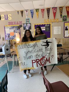 two girls holding up a sign that says, although you can't take the man out of me prom