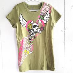 Nwot Green T-Shirt With Skull , Angel Wings, Heart,And Animal Print. Never Been Worn. Skull And Wings Have Glitter On Them. Size L 10/12. Like 2 More Items With A And Get All 3 For $21! Fitted Trendy T-shirt With Skull Print, Skull Print Tops For Spring Streetwear, Trendy Cotton T-shirt With Skull Print, Trendy Cotton Skull Print Tops, Green Skull Print Top For Streetwear, Green Skull Print Tops For Streetwear, Green Skull Print Streetwear Top, Spring Skull Print Short Sleeve T-shirt, Spring Short Sleeve T-shirt With Skull Print