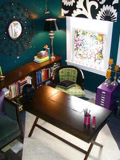 a room with a desk, chair and bookshelf