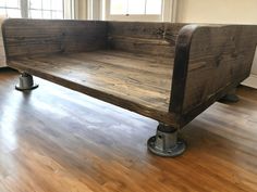 a wooden bench sitting on top of a hard wood floor