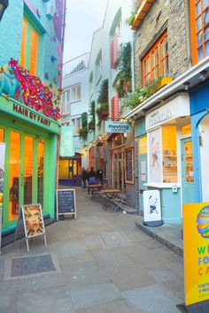 an alley way with shops and restaurants on both sides